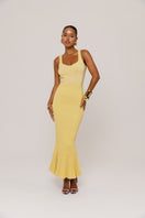 Yellow metallic knit maxi dress by Andreeva featuring a fitted silhouette and long sleeves, styled for a chic evening look.