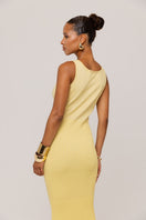 Yellow metallic knit maxi dress by Andreeva featuring a fitted silhouette and long sleeves, styled with a flowing skirt.