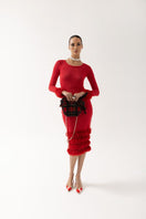 Andreeva red knit top featuring handmade knit details, long sleeves, and a cozy, stylish design.