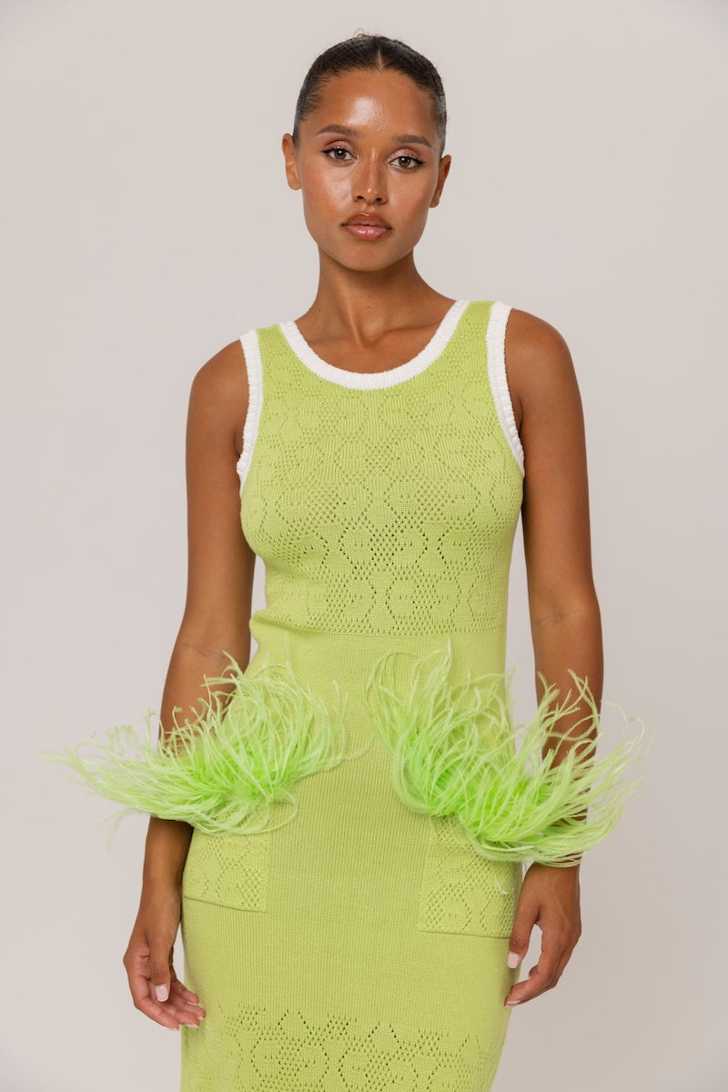 Green knit midi dress by Andreeva featuring a fitted silhouette and long sleeves, displayed on a hanger.