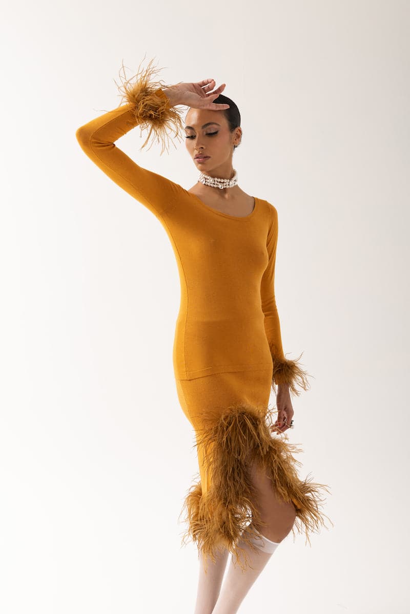 Andreeva camel knit top with detachable feather cuffs, featuring a cozy knit fabric and stylish feather detail at the sleeves.