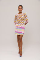 Handmade pink and yellow crochet top featuring a bird of paradise design by Andreeva, showcasing vibrant, intricate craftsmanship.