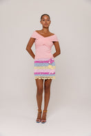 Andreeva Lily Light Pink Knit Top displayed on a hanger, showcasing soft fabric and stylish design for casual wear.