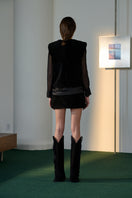 Black Olympia sweater by Lorena Saravia, close-up of the stylish knitted tops with a cozy fit and modern design.