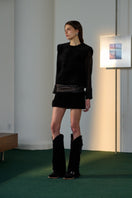 Black Olympia sweater by Lorena Saravia, cozy long-sleeve top with a relaxed fit, shown on a model.
