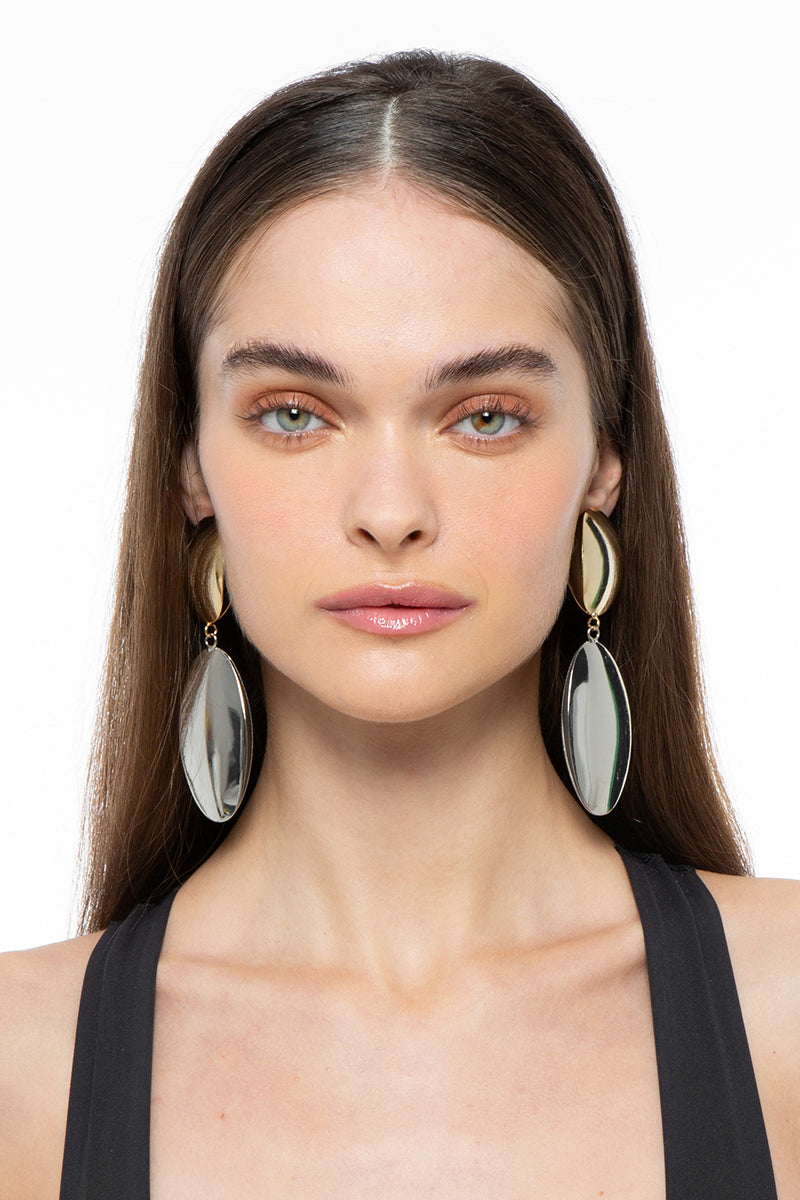 Silver and gold earrings from Silvia Gnecchi's TARA collection, featuring elegant, handcrafted jewelry with intricate design details.