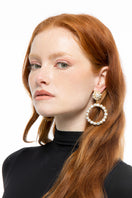 Silvia Gnecchi Lievna earrings featuring elegant silver hoops with intricate detailing, showcased against a neutral background.