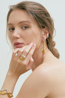 Gold Eugenia Ospina Origen earrings featuring elegant, handcrafted design with intricate detailing and a polished finish.