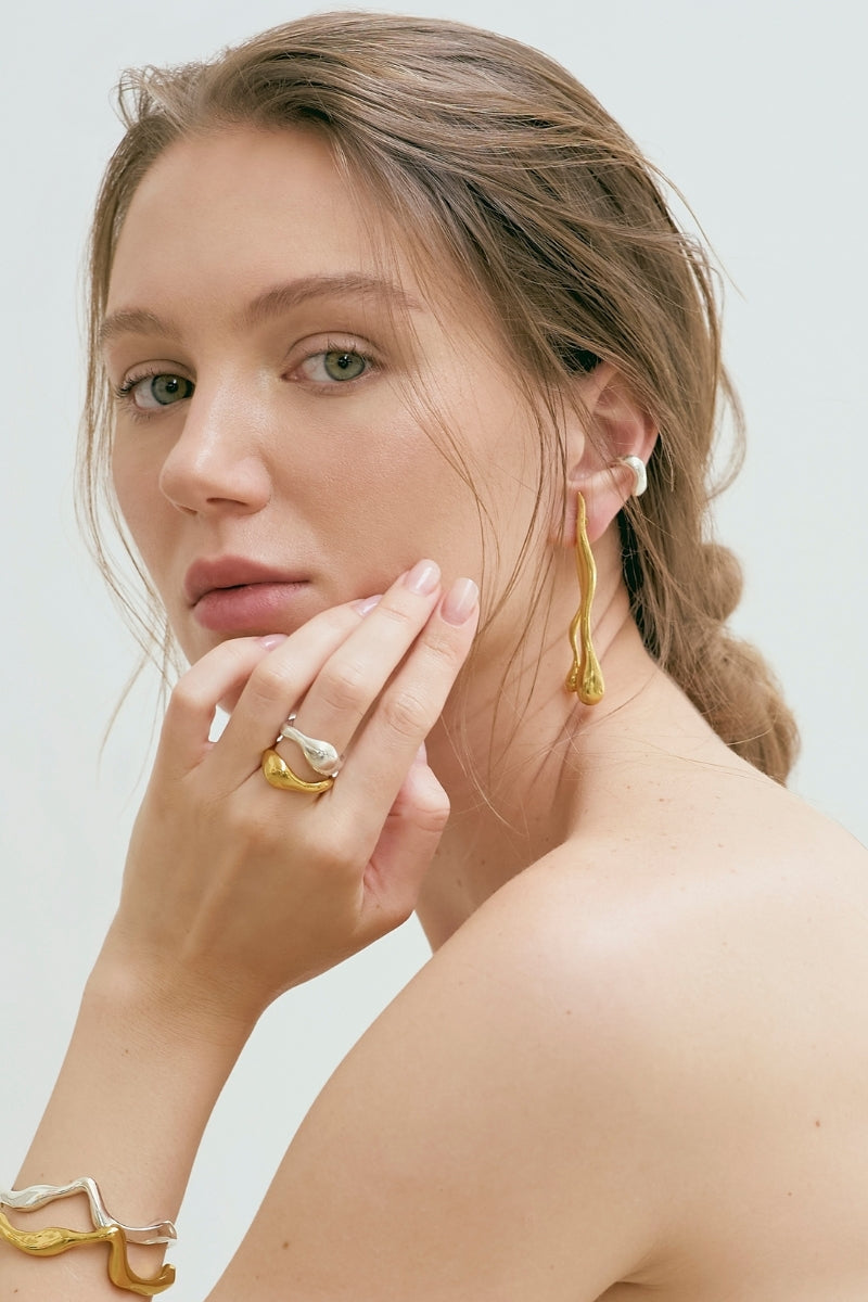 Gold Eugenia Ospina Origen earrings featuring elegant, handcrafted design with intricate detailing and a polished finish.