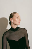 Silver Eugenia Ospina Origen earrings featuring intricate designs with dangling silver elements.