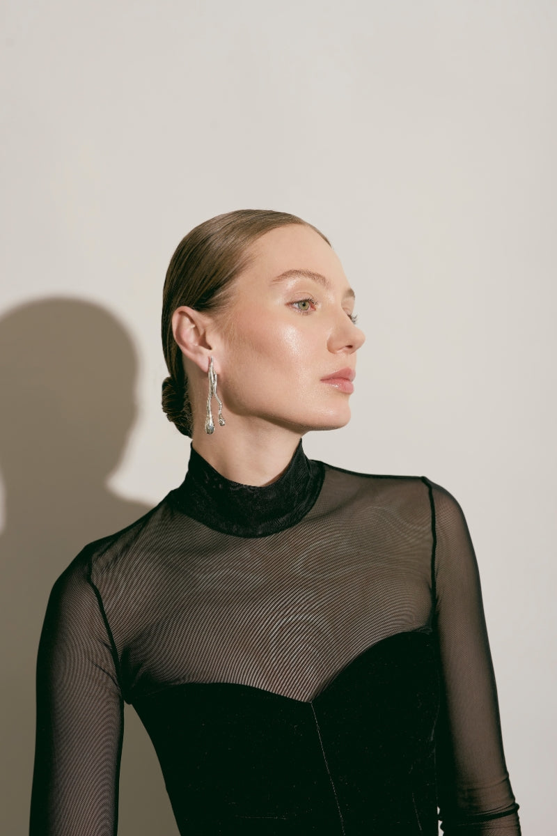 Silver Eugenia Ospina Origen earrings featuring intricate designs with dangling silver elements.