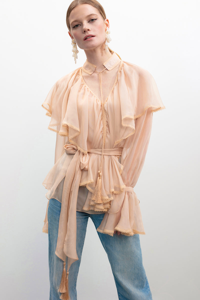 Beige OCEAN OF THE TENDERNESS blouse by OVERTHESEA, featuring soft fabric and a relaxed fit, styled on a model.