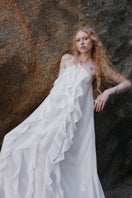 White AQUA dress maxi dress by OVERTHESEA, flowing fabric, sleeveless design, and elegant silhouette perfect for summer wear.