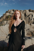 Overthesea black insomnia midi dress displayed on a mannequin, showcasing its sleek design and elegant fit.