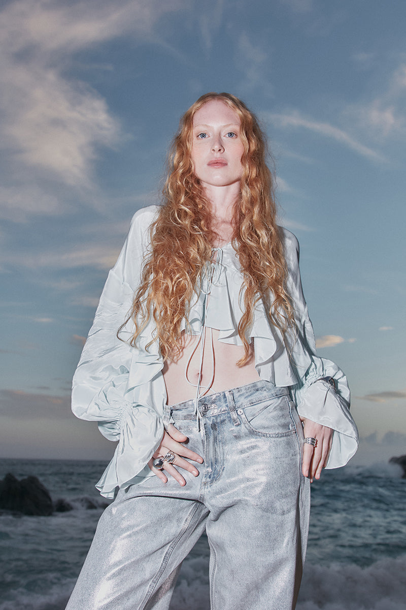 Sky blue Splash blouse by OVERTHESEA, featuring a flowy top with long sleeves and a relaxed fit, perfect for casual wear.