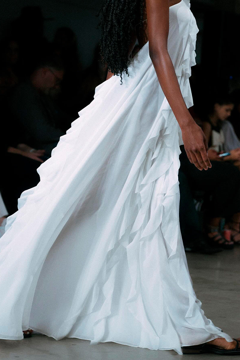 White AQUA maxi dress by OVERTHESEA, flowing fabric, sleeveless design, and elegant silhouette perfect for summer wear.
