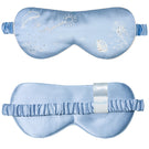 Manito ocean blue silk eye mask resting on a soft surface, designed for comfortable home use and relaxation.