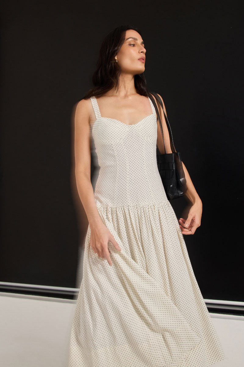 Ivory dot midi dress from Summer Away's Odessa collection, featuring a flowing silhouette and lightweight fabric.