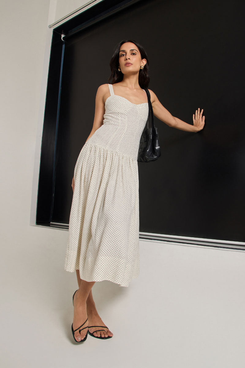 Ivory dot midi dress by Summer Away featuring a flowing silhouette and charming pattern, perfect for summer occasions.