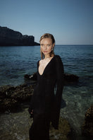 Black OLYA maxi dress by Suncillo displayed on a model, featuring a flowing silhouette and elegant design.