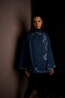 Nadya Shah Olympia denim cape jacket with frayed edges and adjustable tie closure, stylish outerwear for a casual look.