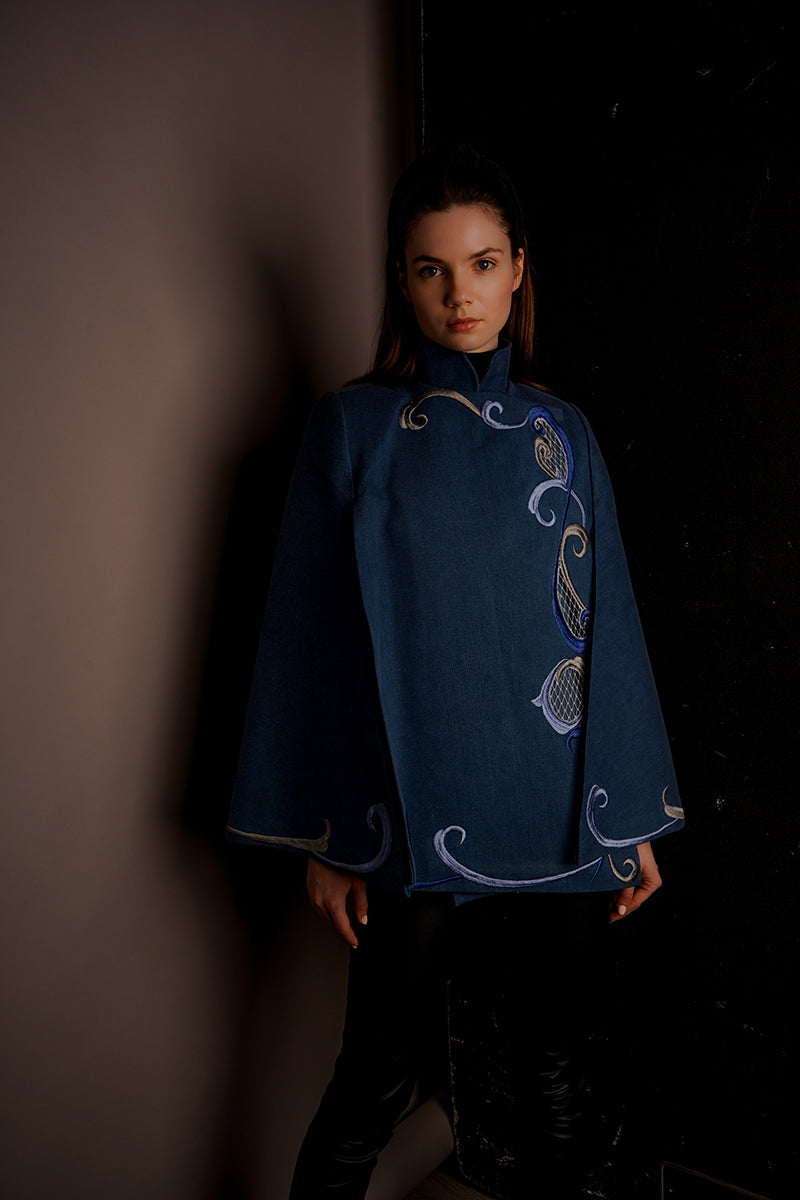 Nadya Shah Olympia denim cape jacket with frayed edges and adjustable tie closure, stylish outerwear for a casual look.