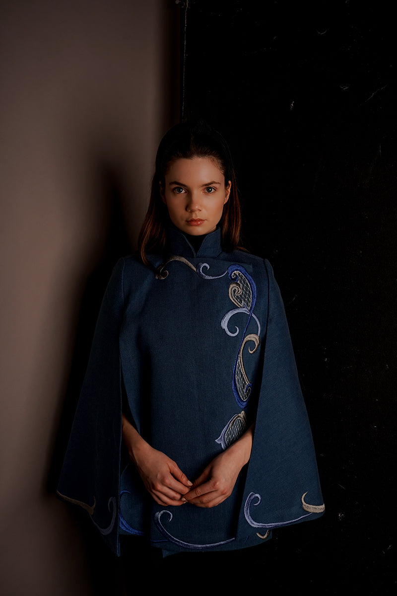 Nadya Shah Olympia denim cape jacket featuring classic blue denim fabric and stylish design, displayed on a model.
