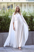 Model wearing SemSem CULT MIA X SEMSEM white silk chiffon kaftan with crystal neckline, flowing maxi dress on a woman.