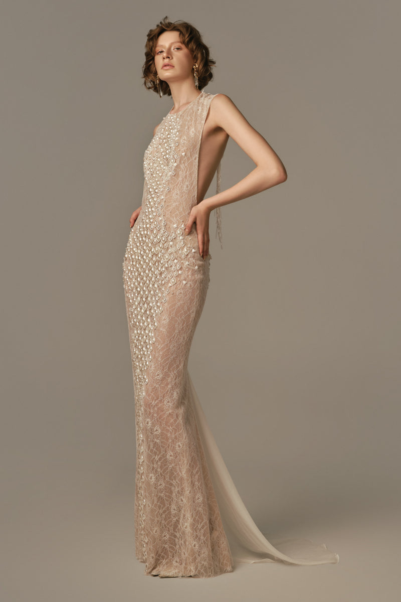 Poem Ondine gown in white, elegant long dress with flowing fabric and delicate details, worn by a model.