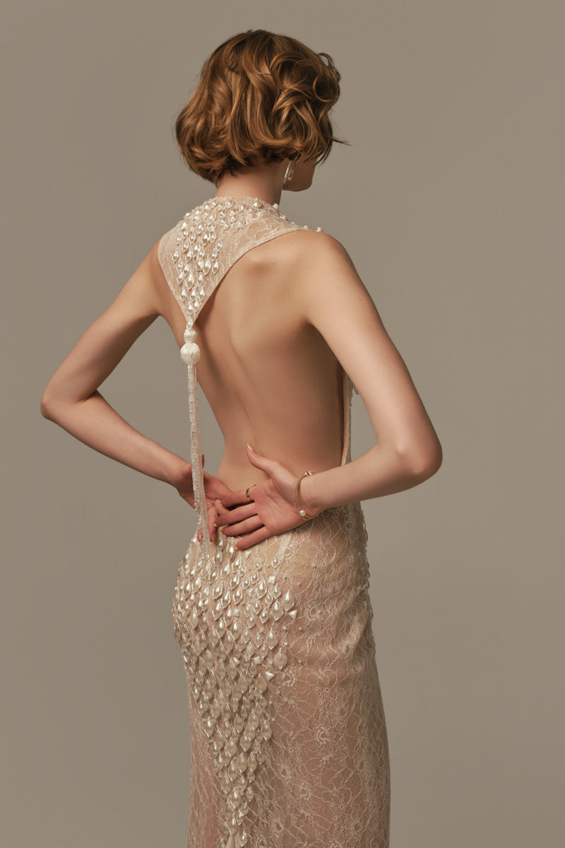 White POEM Ondine gown displayed on a model, showcasing elegant fabric and flowing design perfect for formal occasions.