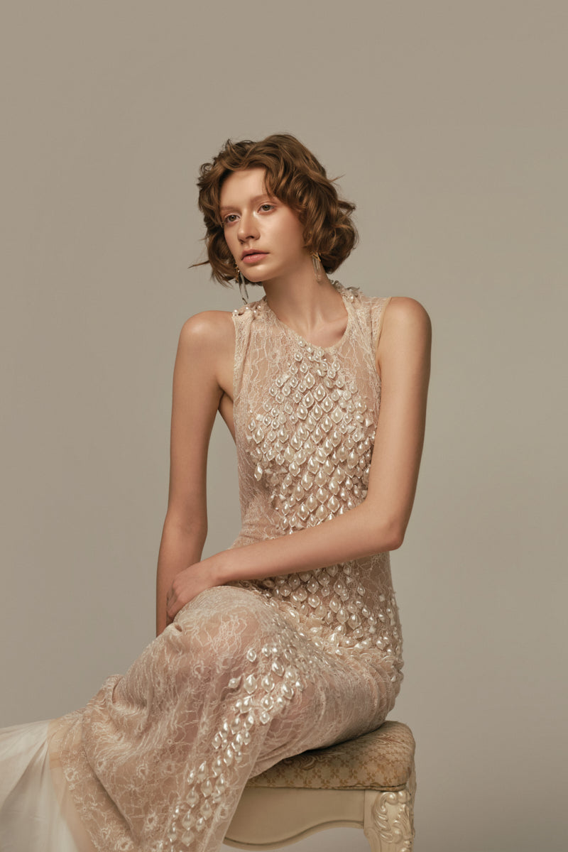 White POEM Ondine gown displayed on a model, showcasing elegant fabric and flowing design perfect for formal wear.
