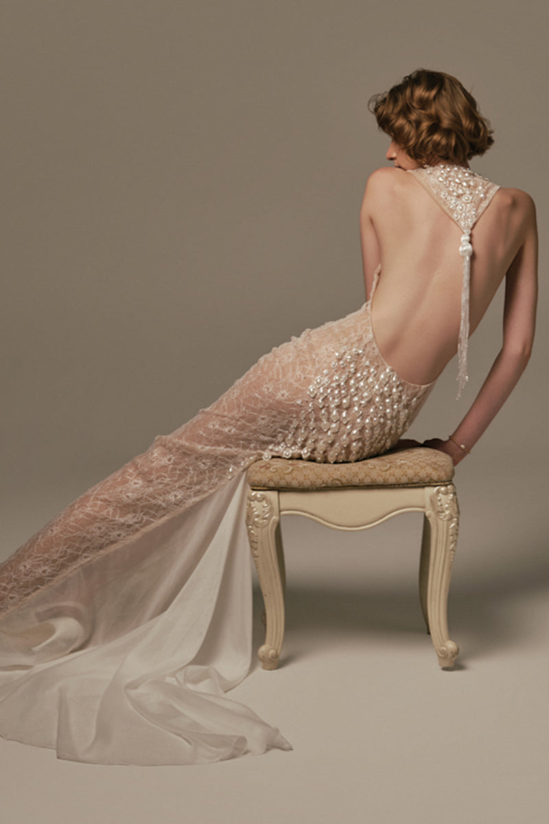 White POEM Ondine gown displayed on a model, showcasing elegant fabric and flowing design suitable for formal occasions.