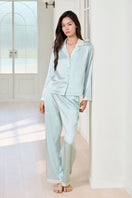 Green silk women's pajama set by MANITO, featuring a comfortable top and matching pants for elegant sleepwear.