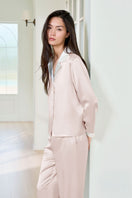 Pink silk pajama set for women by MANITO, featuring a comfortable, elegant design with long sleeves and a relaxed fit.
