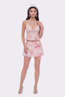 Beige floral mini skirt from Nana Jacqueline's Ophelia collection, featuring a delicate rosette print and stylish design.