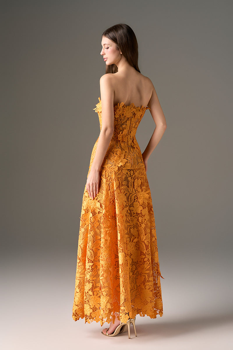 I.H.F Studio Cult Mia X floral garden orange strapless A-line maxi dress displayed on a hanger with floral pattern and flowing fabric.