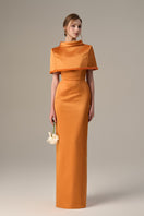 Orange taffeta gown with a cropped cape and inverted lapel by I.H.F, showcasing elegant detail and vibrant color.