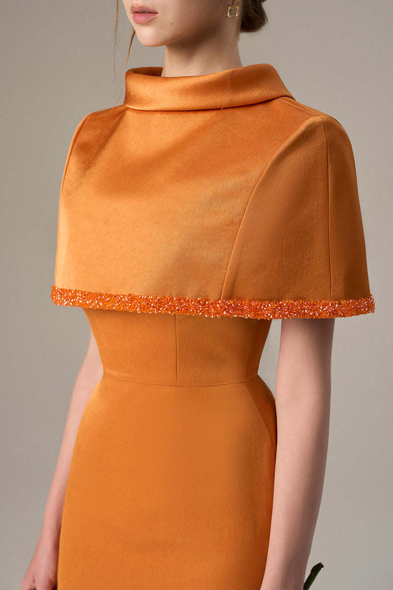 Orange taffeta maxi dress by I.H.F featuring a cropped cape and inverted lapel, displayed on a mannequin.