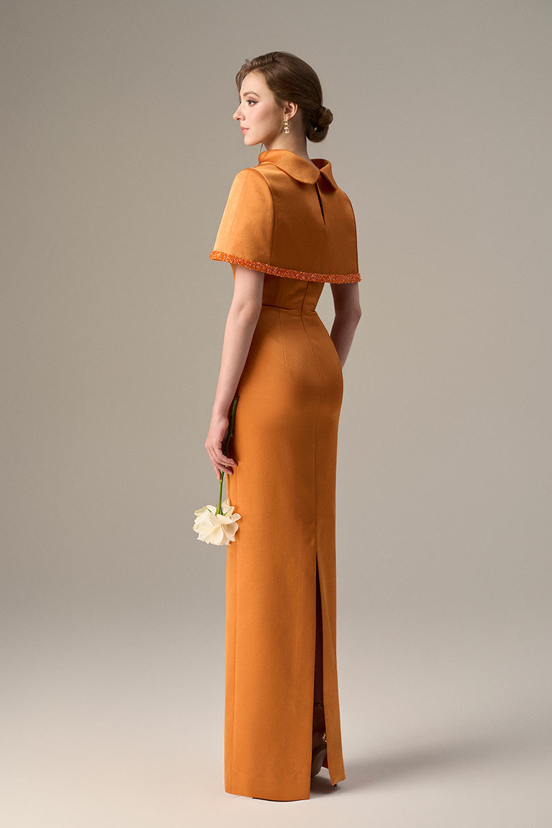 Orange taffeta maxi dress with a cropped cape and inverted lapel by I.H.F, featuring a stylish and elegant design.