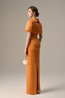 Orange taffeta gown with a cropped cape and inverted lapel by I.H.F, featuring elegant design and flowing fabric.