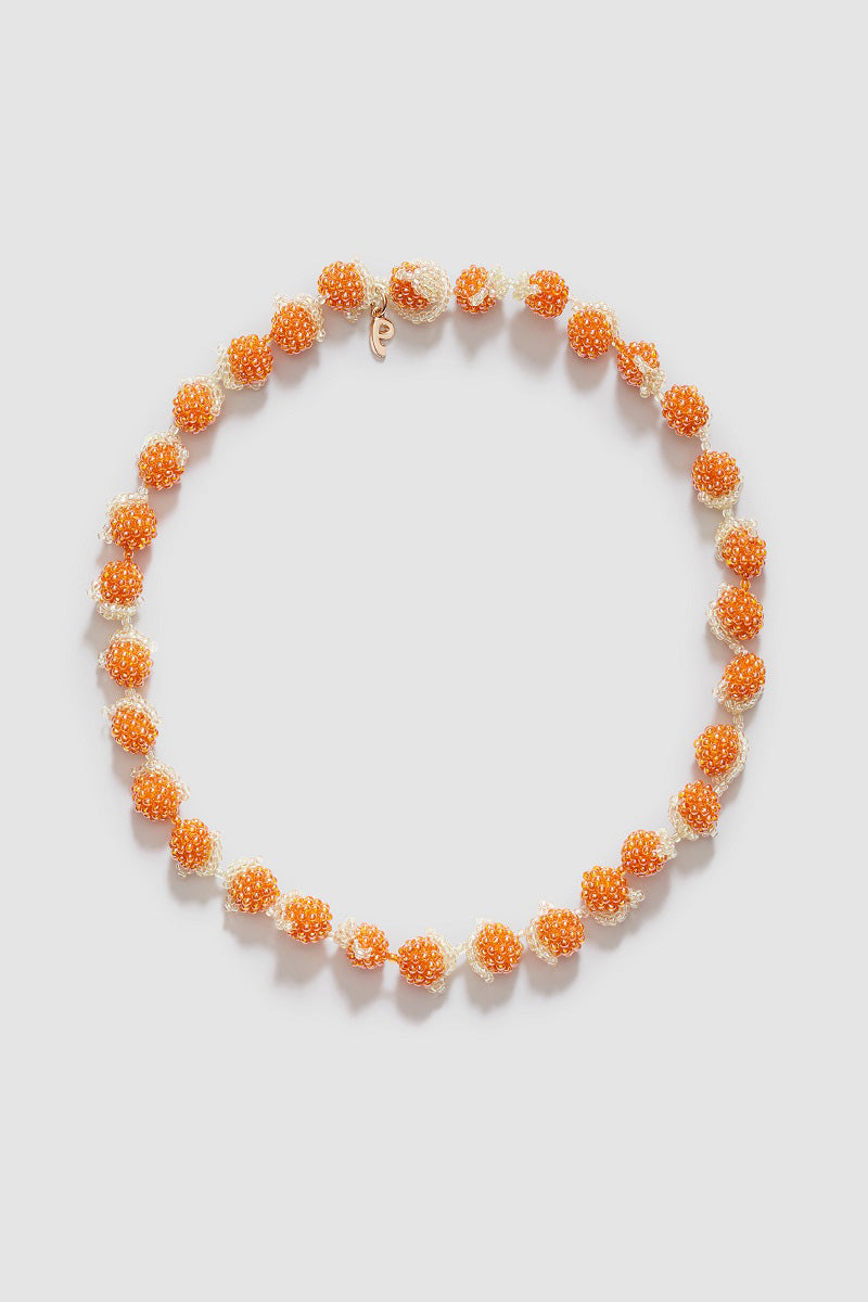Pura Utz Orange Galore Necklace featuring vibrant orange beads and a stylish design, perfect for adding a pop of color to your outfit.
