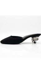 Black Orbit Heels by Yassmin Saleh, stylish women's heels with sleek design, shown outdoors on a ghostly background.