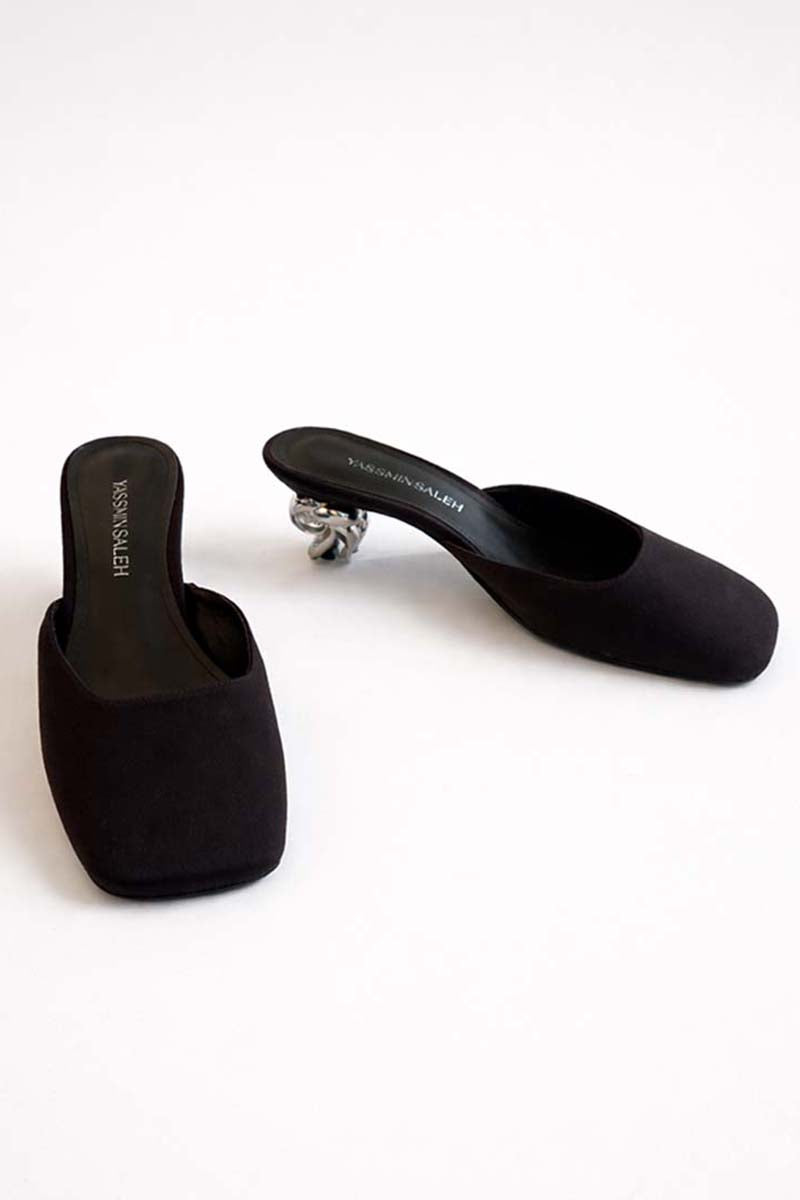 Black Orbit heels by Yassmin Saleh featuring sleek design and stiletto heel, displayed on a neutral background.