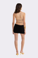 Black Nana Jacqueline Oriana mini dress with an open back and fitted silhouette, perfect for stylish evening wear.