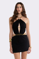 Black Nana Jacqueline Oriana mini dress with an open back, showcased on a model in a stylish fashion lookbook.