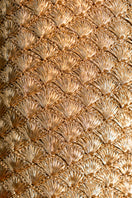Close-up of Verdi gold seashell clutch showing detailed textured gold surface and elegant design.