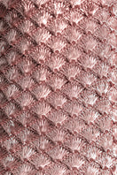 Close-up of VERDI seashell clutch in rose gold with intricate shell details and elegant compact design.