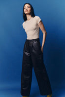 ZUT oversized chocolate croc-embossed pants with a relaxed fit and wide-leg design, shown on a model.