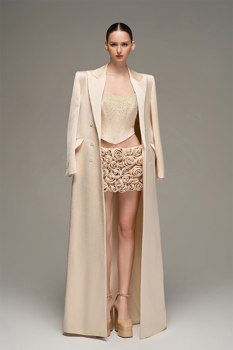 Beige double-breasted long coat by I.H.F Studio featuring an oversized, straight-cut design, displayed on a hanger.