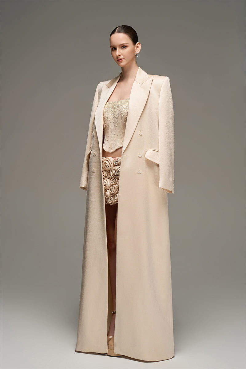 Beige double-breasted long coat by I.H.F Studio with an oversized, straight-cut design shown on a model.